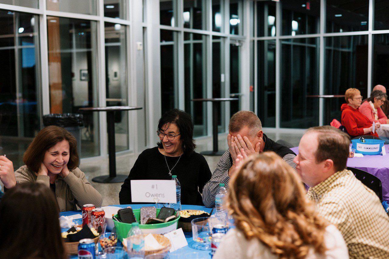 A table laughing at Trivia Night