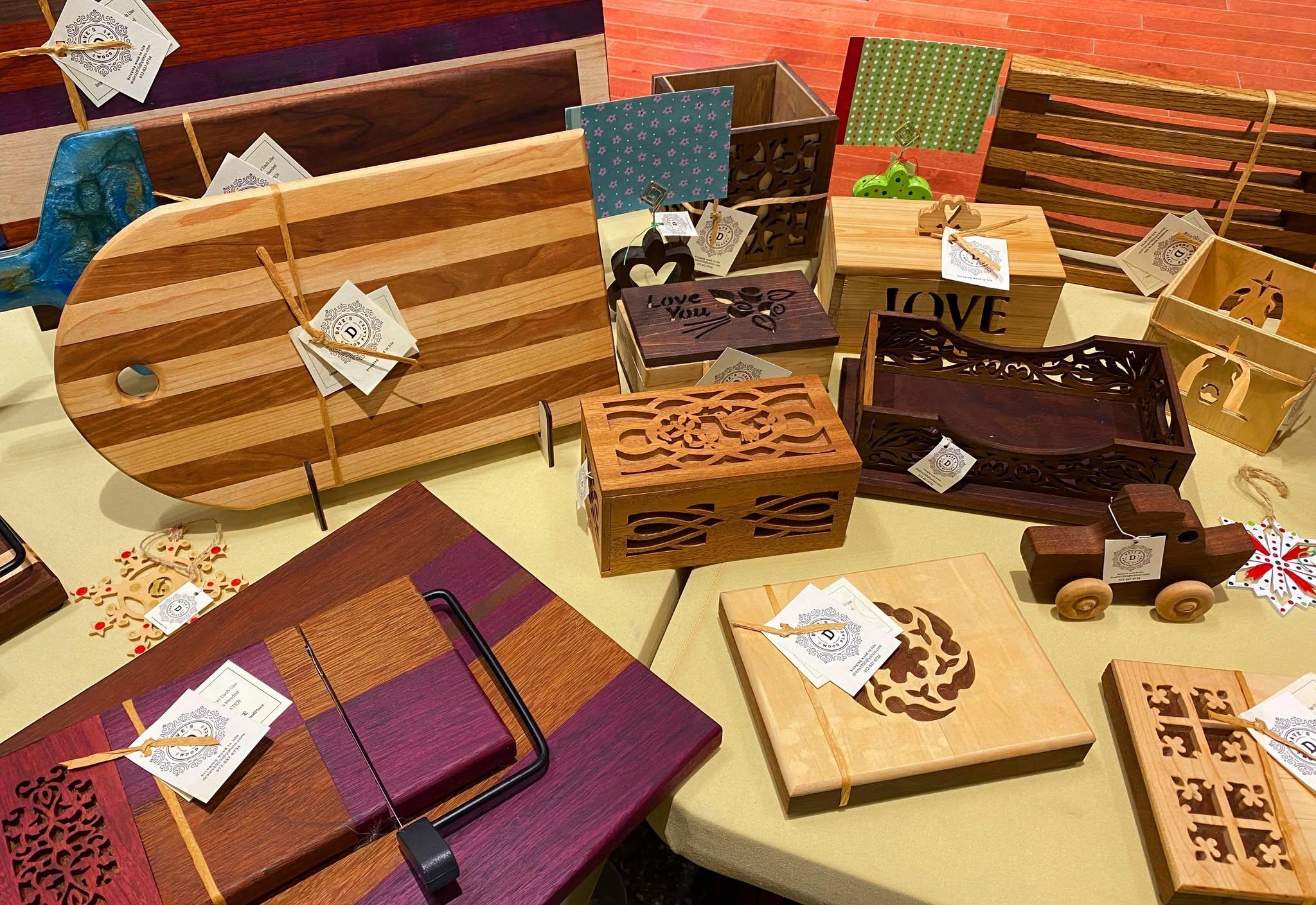 Handcrafted woodworking gifts laid out on a display table